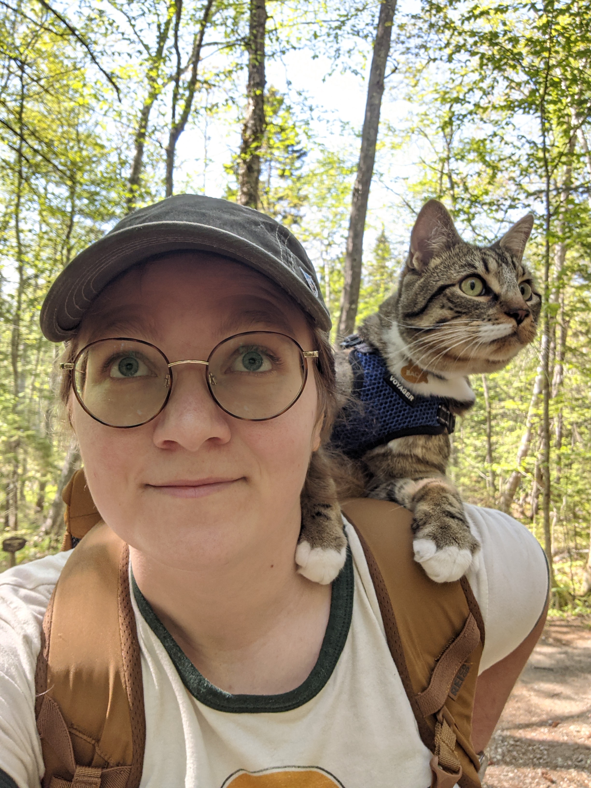 Photo of woman in woods with cat on her shoulder